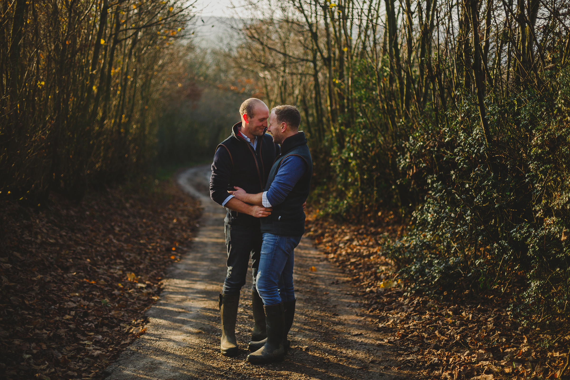 gay farmers cuddling in a country lane 